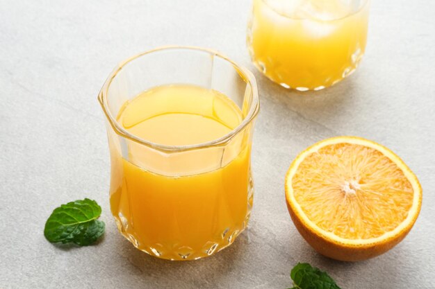 Orange juice in glass with fresh fruits on the table Selective focus and blurred background