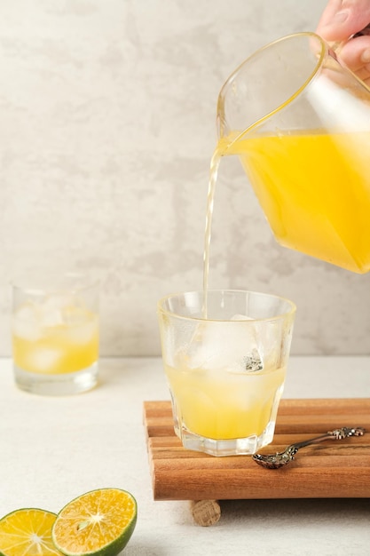 Orange juice in glass with fresh fruits on the table Selective focus and blurred background