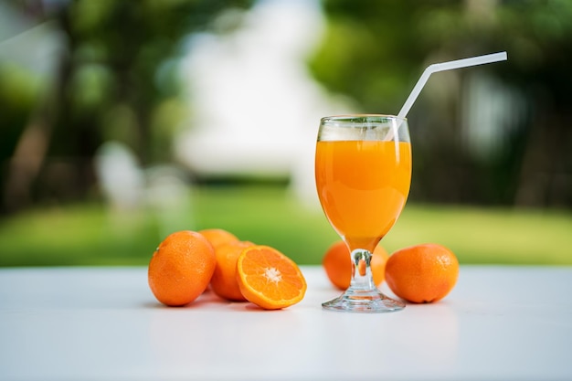 Orange juice and orange halves on the natural background