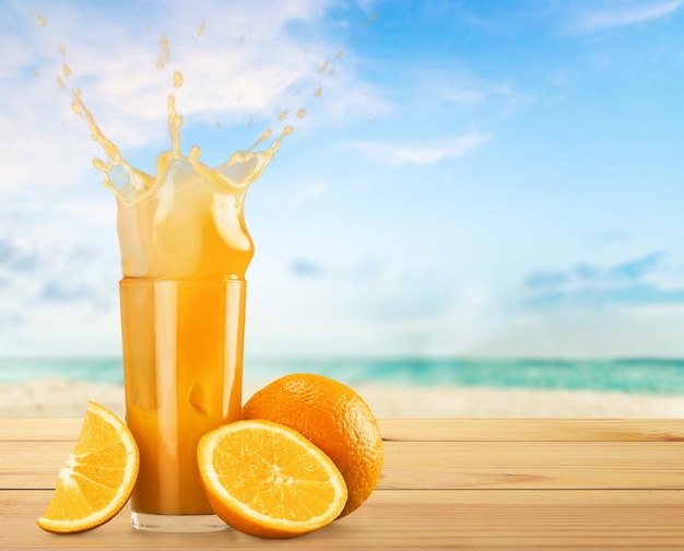 Orange juice and slices of orange on background