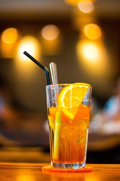 Orange Juice on a Wooden table with lemon piece