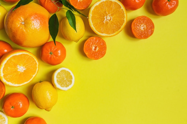 Orange, lemon, citrus fruits flat top view pattern on yellow background