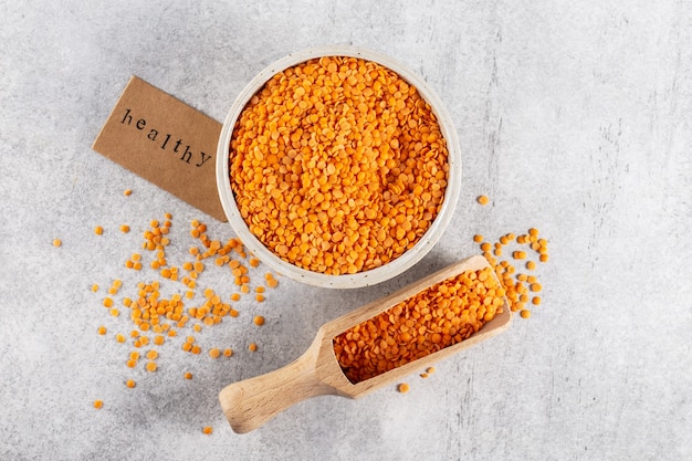 orange lentils in a bowl on a gray stone background