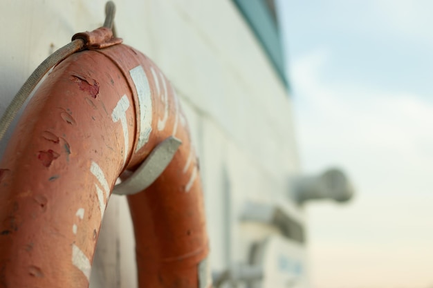 Orange lifebuoy aboard a yacht or ship closeup with copy space Marine tourism