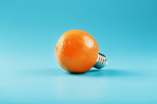 Orange light bulb on a blue background