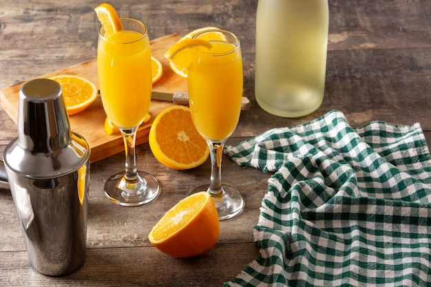 Orange mimosa cocktail on wooden table