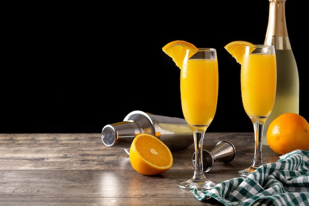 Orange mimosa cocktail on wooden table