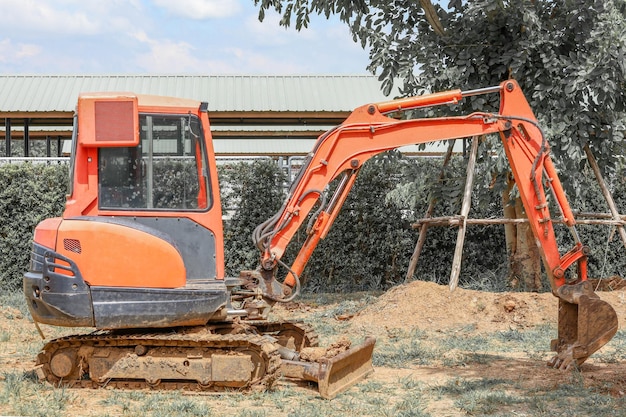 The orange mini backhoe stop in Construction site