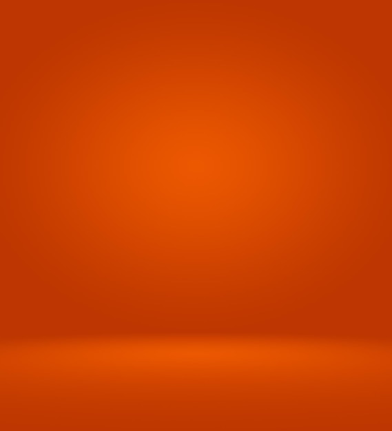 Orange photographic studio background vertical with soft vignette. Soft gradient background. Painted canvas studio backdrop.