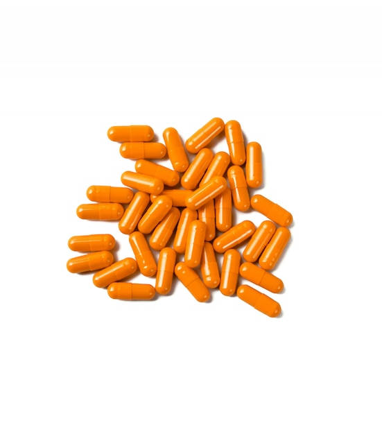 Orange pill capsules isolated on white surface