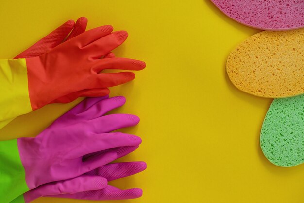 orange and pink rubber gloves and washing sponge