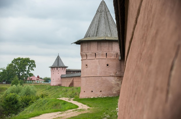 An orange protective brick wall with observation towers in small village