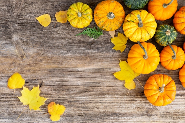 Orange pumpkins on the old wooden table