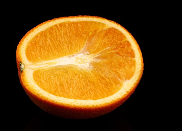 Orange sliced on black surface