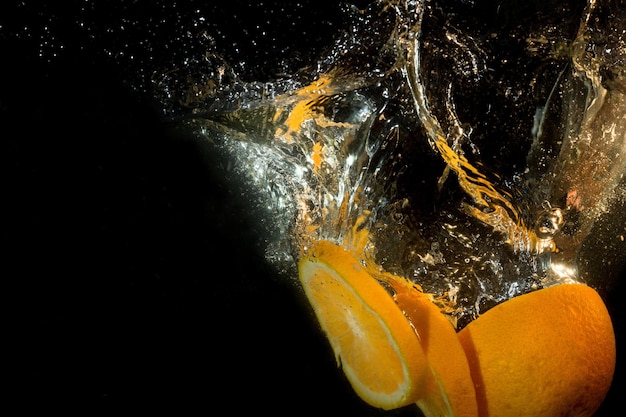 Orange slices are falling into the water