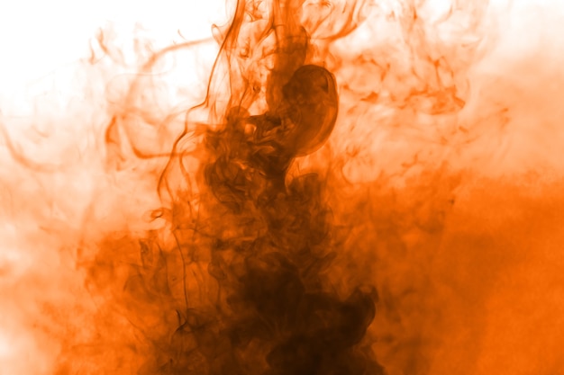 Orange smoke flow on white background.