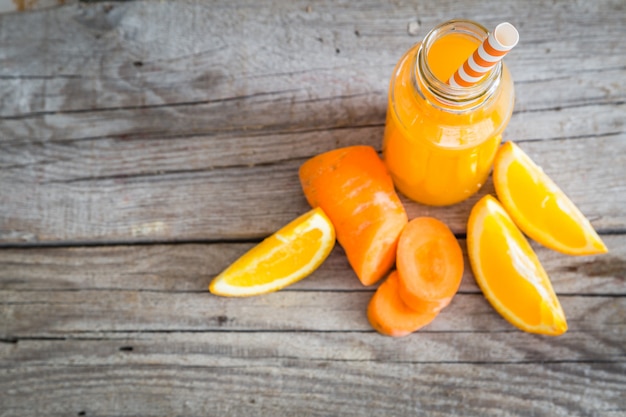 Orange smoothie on rustic wood  