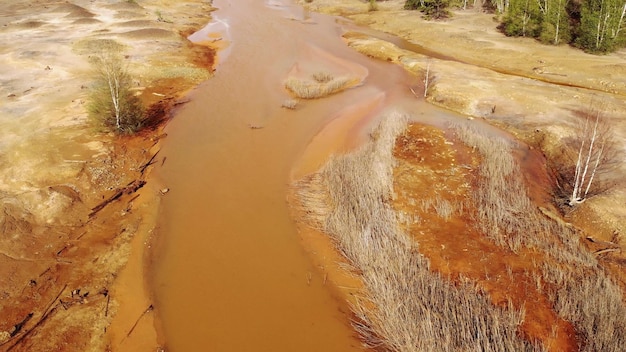 Orange soil is contaminated with heavy metals from an industrial plant Chemical pollution of soil toxic waste