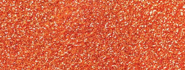 Photo orange sparkling background from small sequins macro ginger shiny backdrop with glitter pattern