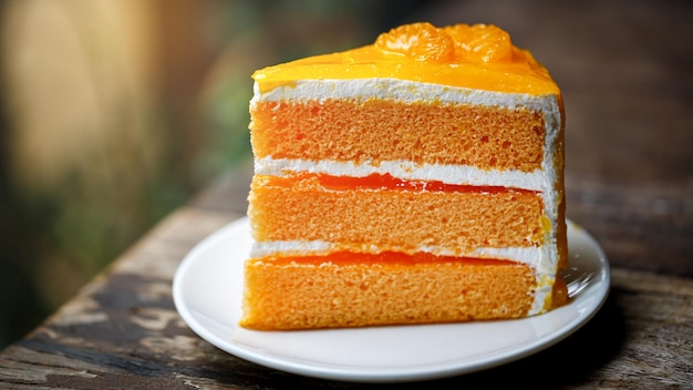 Orange sponge cake on wooden table