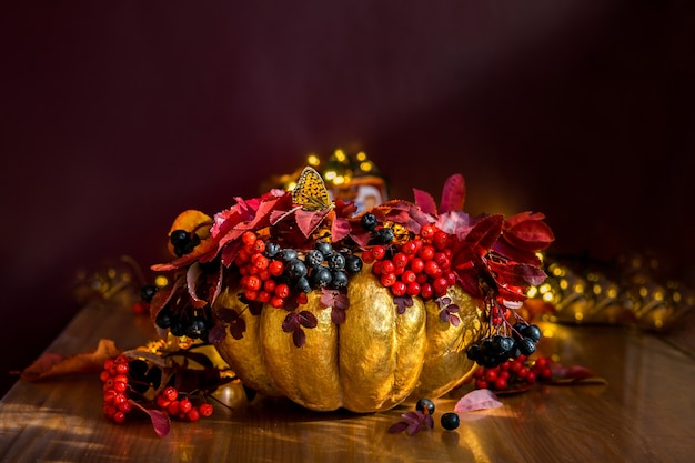 Orange still life with pumpkin and berries, figs, dry leaves and physalis flowers. High quality photo