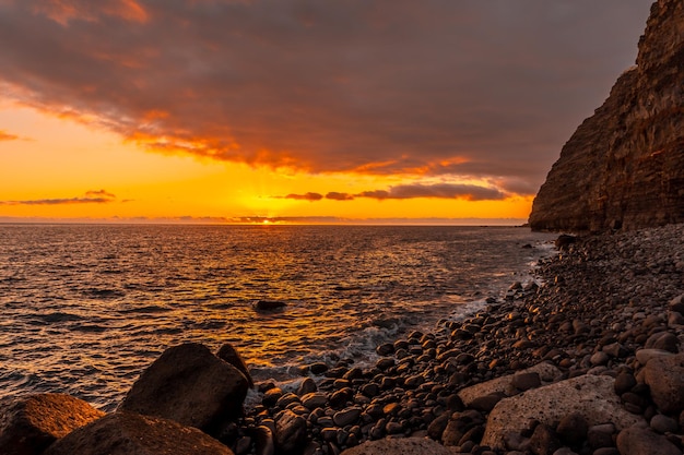 Orange sunset on the beach of Puerto de Tazacorte on the island of La Palma Canary Islands