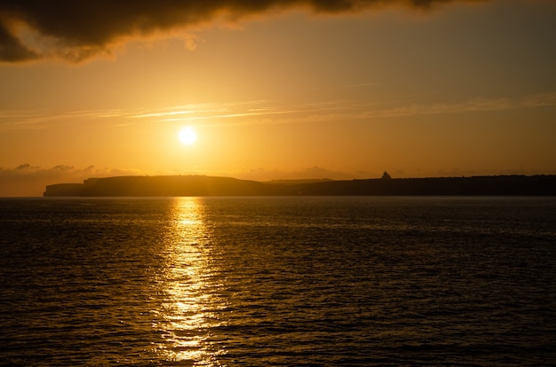 Orange Sunset in sea in Gozo