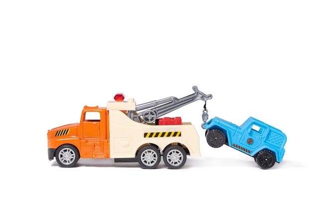 An orange tow truck is towing a blue car Toy cars on white background