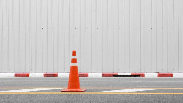 Orange traffic cone on asphalt road