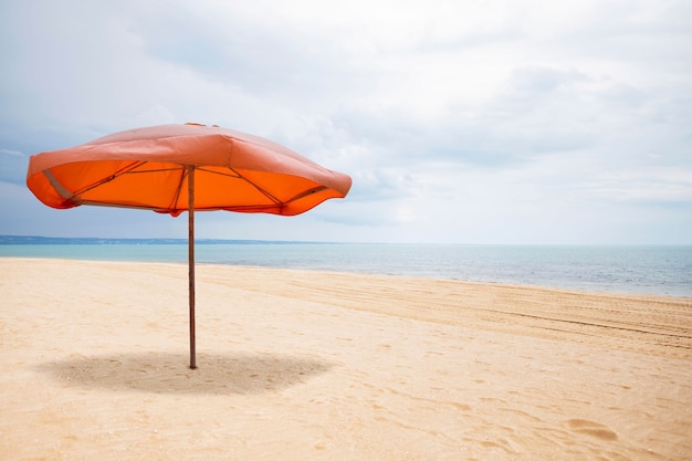 Orange umbrella on the beach collage