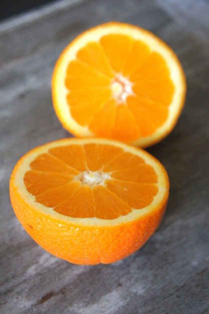 Orange with half cut on a marble background