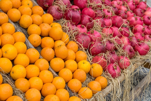 Oranges, lemons and pomegranates on the counter at the street bazaar.