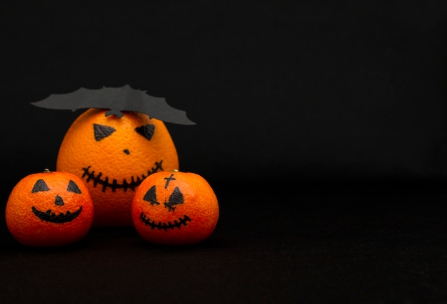 The oranges and mandarins painted like a halloween pumpkin, happy halloween citrus