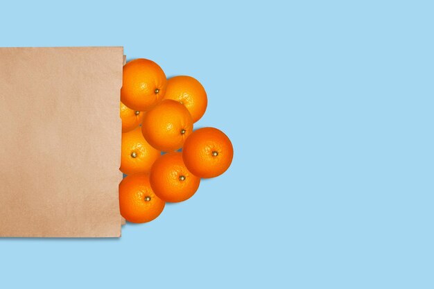 Oranges in a paper bag On a blue background