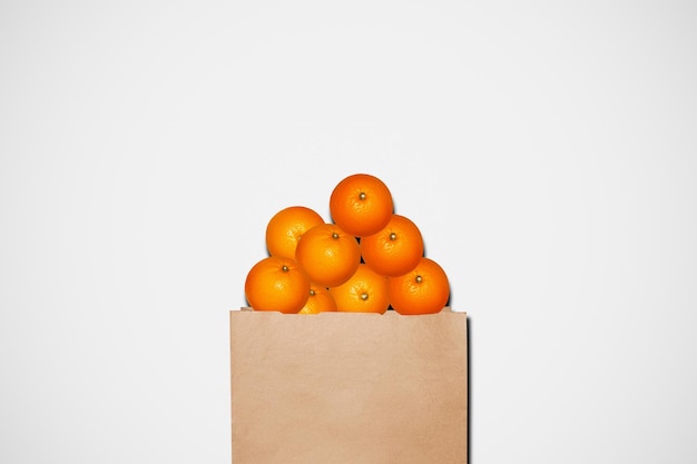 Oranges in a paper bag On a light background