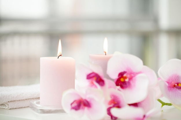 Orchids and burning aromatic candles on spa salon