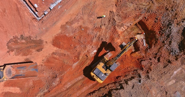 In order to lay underground storm sewer pipes the excavator digs a pit to connect the sewer system