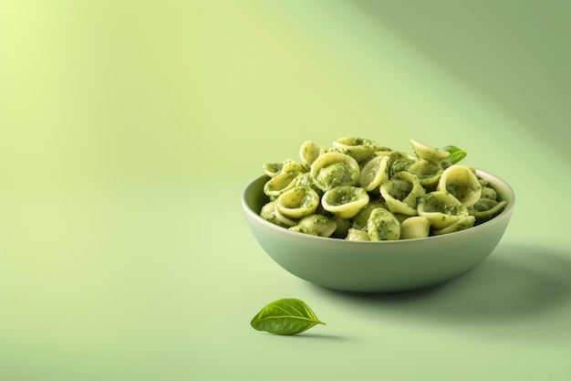 Orecchiette with Pesto Pasta served with pesto sauce and basil Light green color background