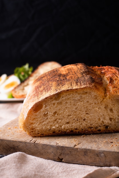 Organic artisan sourdough bread and boiled eggs in white plate