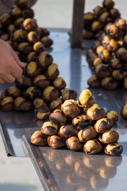 Organic brown chestnuts roasted over a hot fire for sale