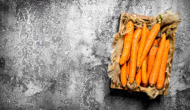 Organic carrots in an old box  On rustic background