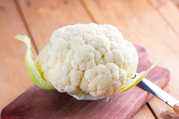 Organic cauliflower on wooden background Fresh head of cauliflower on the wooden board Copy space