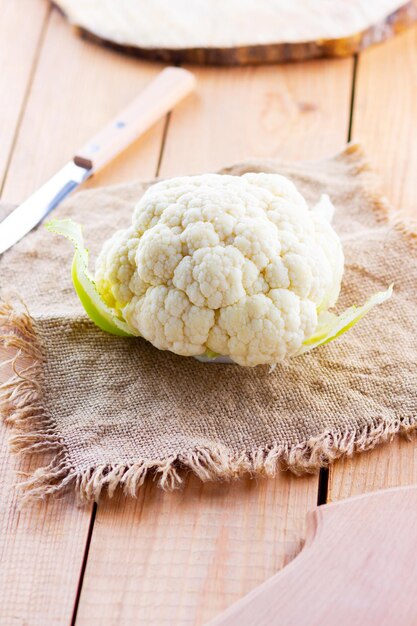 Organic cauliflower on wooden background Head of cauliflower on the burlap Vegetarian food