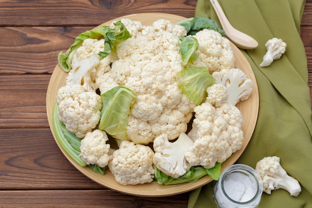 Organic cauliflower on wooden background