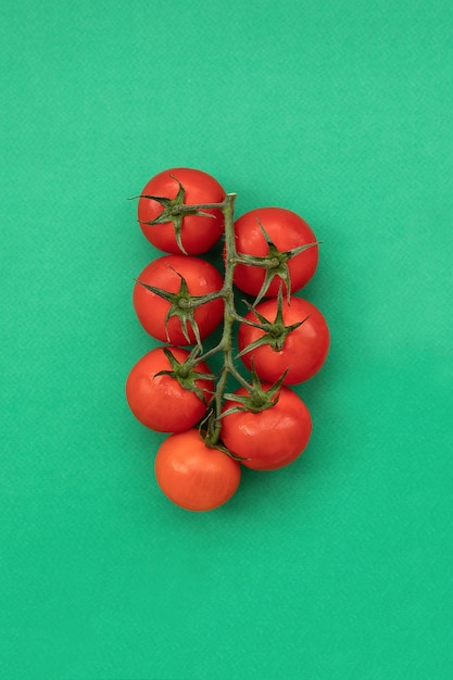 Organic cherry tomatoes on green 