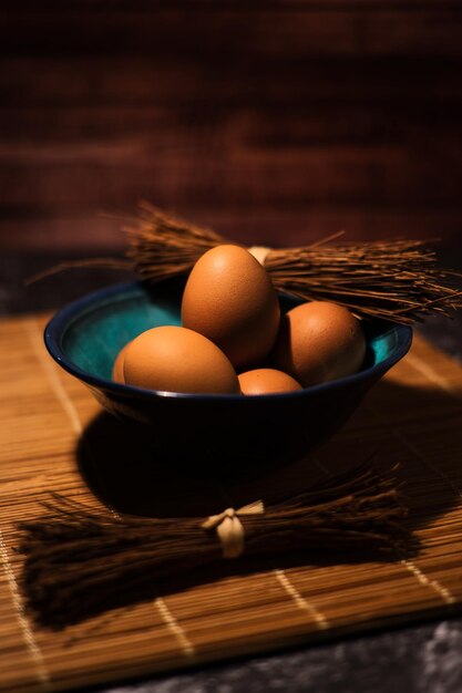 Organic chicken eggs on dark wooden background