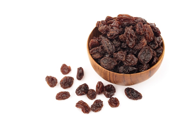 Organic dried Raisins in wooden bowls on white background