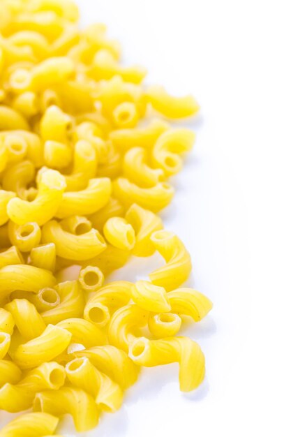 Organic dry pasta on a white background.