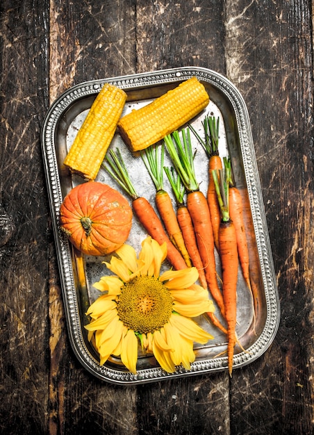 Organic food. Fresh harvest of vegetables. On a wooden background.