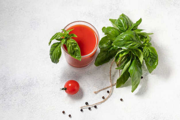 Organic fresh tomato juice in a glass, the concept of vegetables. View from above.